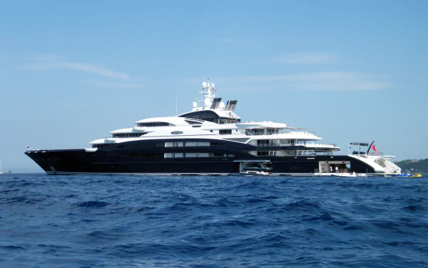 2K Quad HD PC desktop wallpaper: a luxury yacht vehicle gliding on deep blue sea beneath a clear sky.