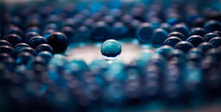 An abstract design featuring a central blue ball surrounded by a pattern of darker orbs, creating a captivating visual depth. A stunning 4K Ultra HD desktop wallpaper.