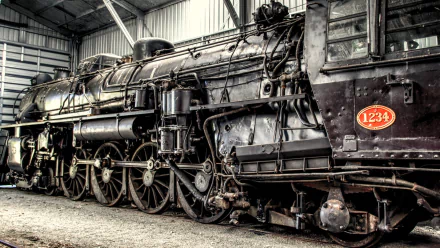 HD PC desktop wallpaper background showing a vintage steam locomotive train vehicle, close-up on wheels, rods and weathered ironwork with red numberplate 1234.