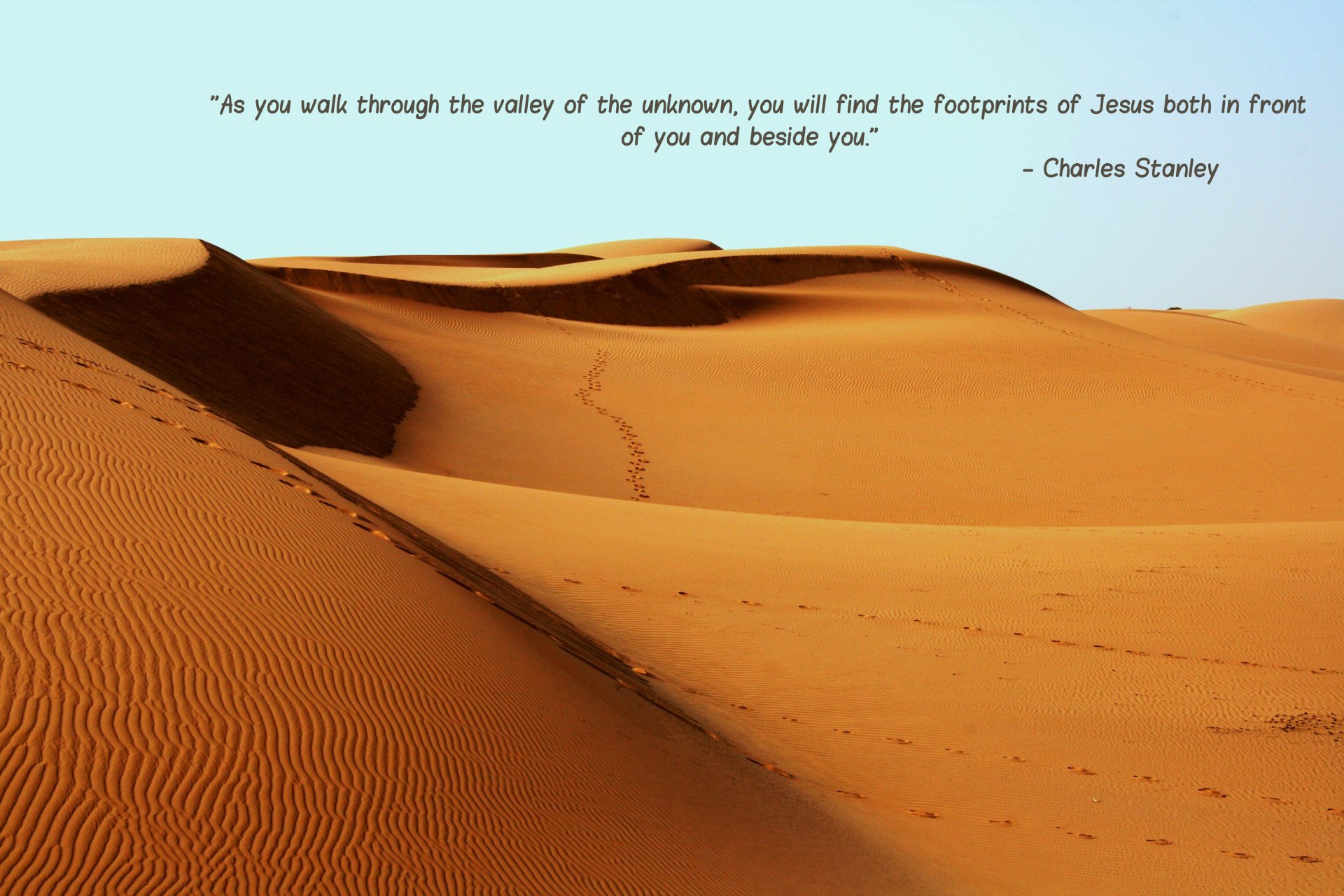 A 4K Ultra HD desert wallpaper featuring a religious quote about Jesus' footprints in the sand, symbolizing faith and guidance through the unknown.