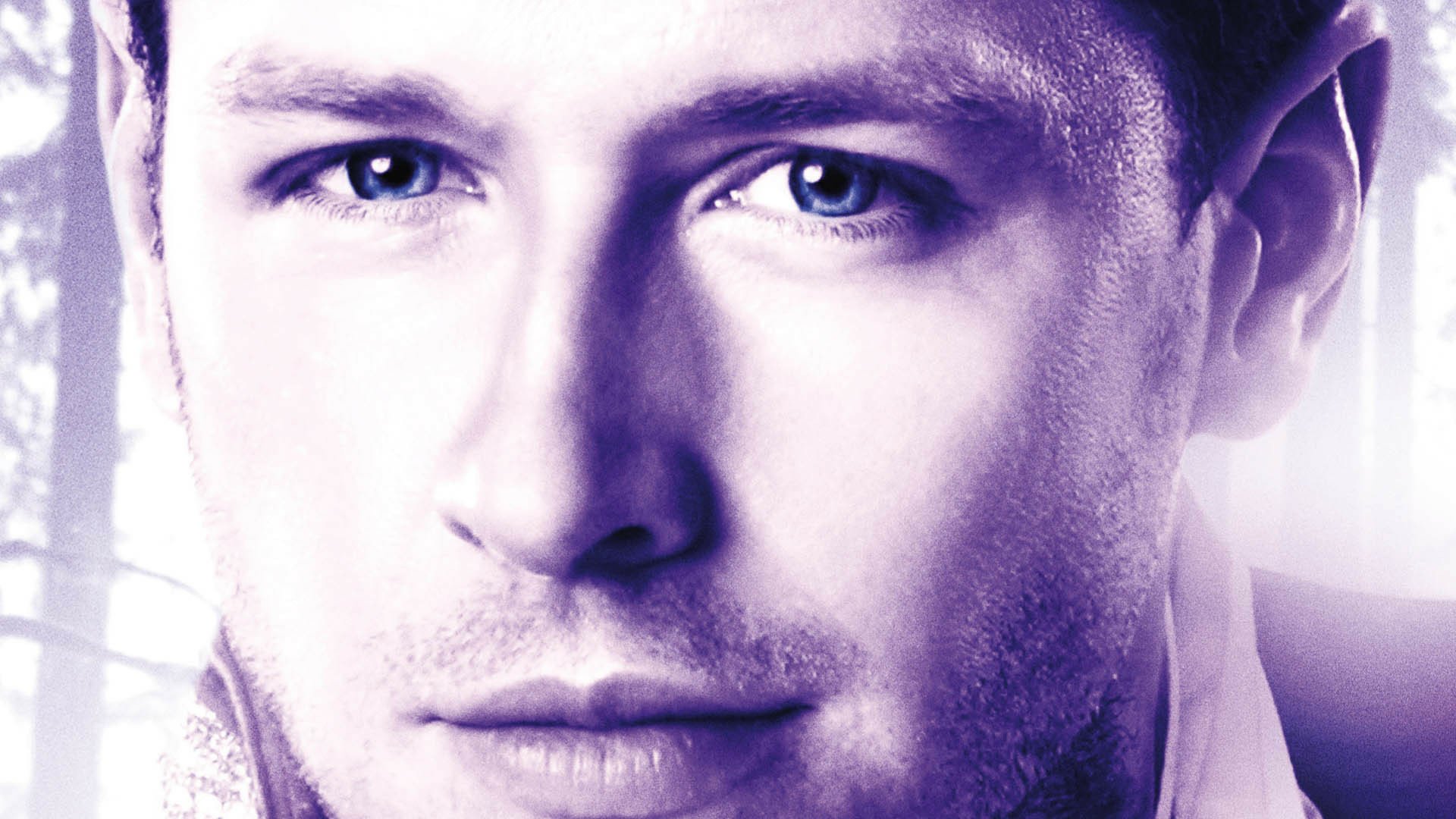 Close-up portrait of a man's face with intense gaze and stylized purple lighting — HD PC desktop wallpaper themed to the TV show Once Upon A Time.