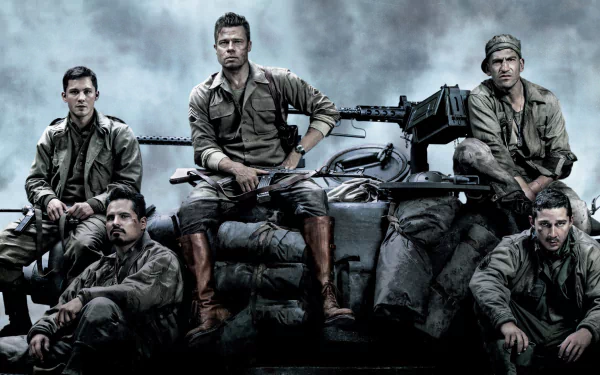 A high-definition desktop wallpaper featuring a group of soldiers from the movie Fury, posing confidently on a tank against a dramatic, overcast background.