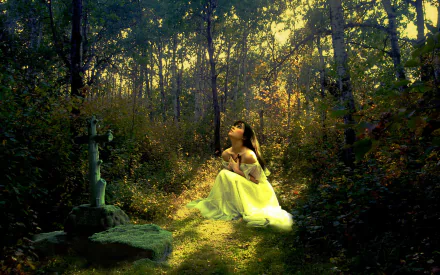 A woman in a white dress kneels in a forest beside a grave with a cross, bathed in dappled sunlight. The image conveys a serene and contemplative mood, captured in high definition as a desktop wallpaper.
