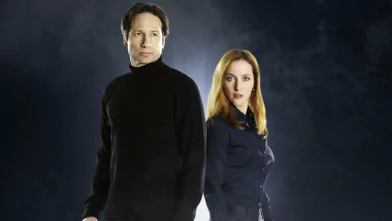 HD PC desktop wallpaper of The X-Files: two agents stand back-to-back against a smoky, shadowed night background.
