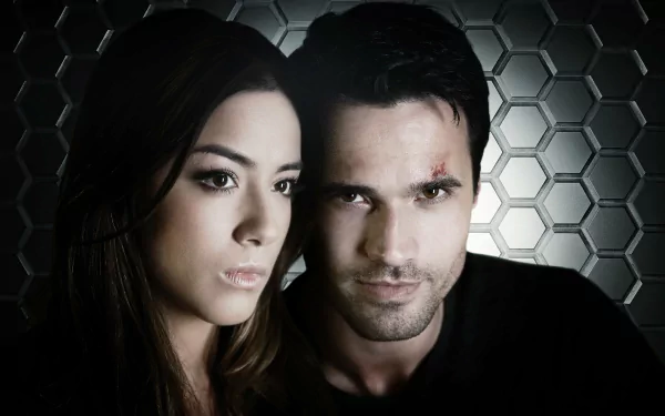 HD desktop wallpaper featuring Daisy Johnson from the TV show Agents of S.H.I.E.L.D., with a dark honeycomb background highlighting the characters' intense expressions.