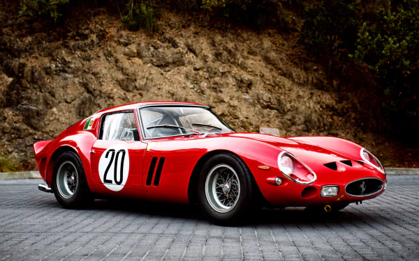 HD desktop wallpaper featuring a red Ferrari 250 GTO supercar with racing number 20, parked on a stone driveway against a rocky backdrop.