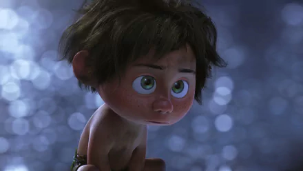 HD desktop wallpaper from the movie The Good Dinosaur, featuring a close-up of a character with large, expressive eyes and tousled hair, set against a soft, out-of-focus background.