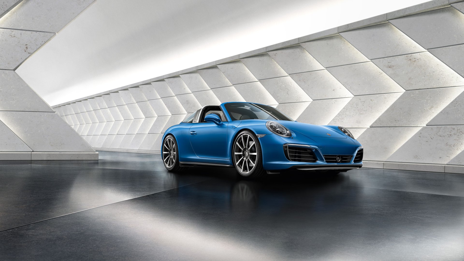 A sleek blue Porsche 911 Targa sports car is showcased in a modern, futuristic setting, captured in high definition as a PC desktop wallpaper and background.