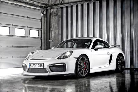 White Porsche Cayman GT4 sports car in an industrial garage — 2K Quad HD PC desktop wallpaper featuring the Porsche vehicle.