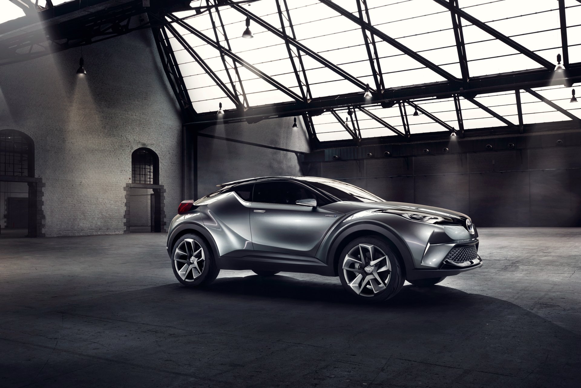 Silver Toyota C-HR concept SUV car — futuristic vehicle with angular lines and large wheels in an industrial loft, 4K Ultra HD PC desktop wallpaper/background.