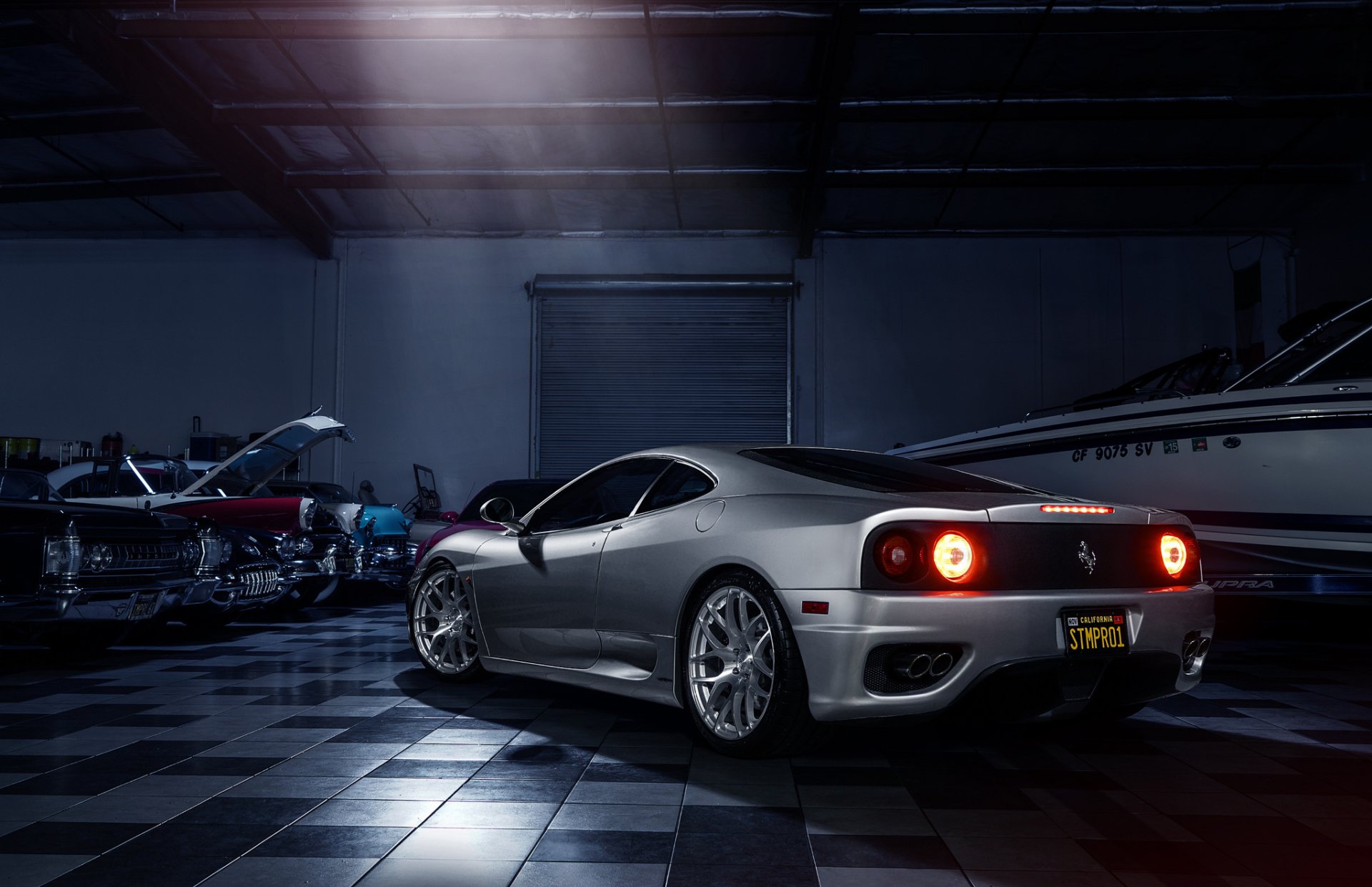 Silver Ferrari 360 Modena supercar showcased in a dimly lit garage, featured as an HD PC desktop wallpaper and background.
