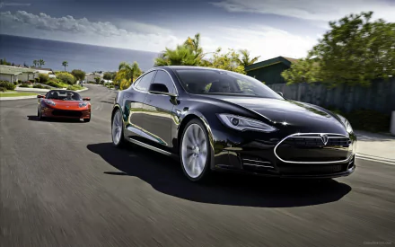 HD PC desktop wallpaper featuring a sleek black Tesla Motors vehicle driving on a sunny road with another Tesla in the background.