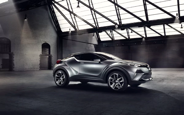 Silver Toyota C-HR concept SUV car — futuristic vehicle with angular lines and large wheels in an industrial loft, 4K Ultra HD PC desktop wallpaper/background.