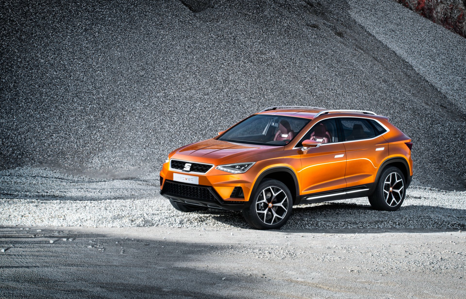 Orange SEAT 20v20 SUV parked on a rocky terrain, showcased in 4K Ultra HD as a PC desktop wallpaper and background.