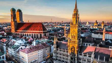 A stunning HD cityscape of Munich, Germany showcasing iconic man-made architecture, including historic churches and buildings under a clear sky.