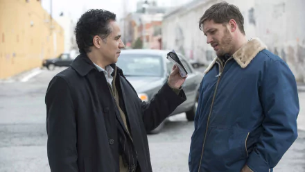 Two men in a gritty urban street scene from the movie The Drop; one holds up an ID to the other — HD PC desktop wallpaper.