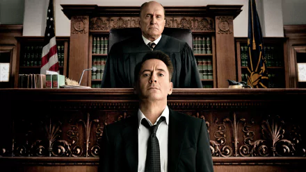 HD PC wallpaper: dramatic courtroom scene from the film The Judge (2014), a stern judge looming over a weary man seated at the defendant's bench.
