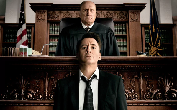 HD PC wallpaper: dramatic courtroom scene from the film The Judge (2014), a stern judge looming over a weary man seated at the defendant's bench.