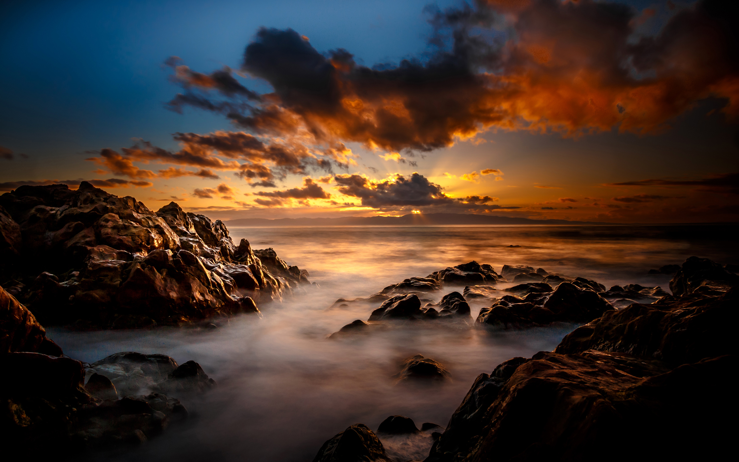 Dark Clouds And Sunset Over Rocky Sea