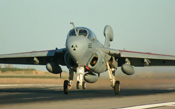 A Northrop Grumman EA-6B Prowler jet fighter takes off on a runway, showcasing its military design and power in this HD desktop wallpaper.
