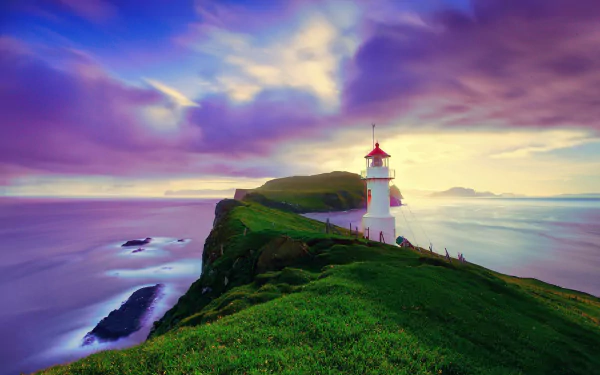 Lighthouse perched on a cliff overlooking the ocean at purple-hued horizon under dramatic clouds in the Faroe Islands, captured in HD for desktop wallpaper.