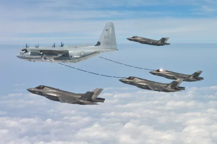 A Lockheed Martin C-130J Super Hercules refuels multiple Lockheed Martin F-35 Lightning II warplanes mid-flight above the clouds in this HD military aircraft wallpaper.