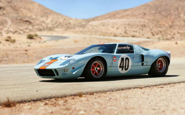 HD PC desktop wallpaper background, Ford vehicle: a light blue Ford GT40 race car (#40) with Gulf stripes speeding on a desert road.
