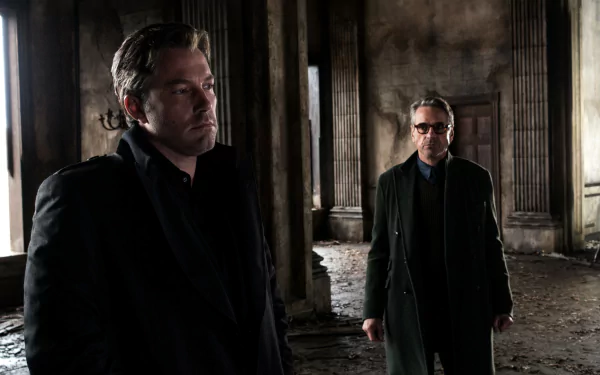 Ben Affleck as Batman and Jeremy Irons as Alfred Pennyworth in a dark, ruined setting from the movie Batman V Superman: Dawn of Justice, shown in 4K Ultra HD.