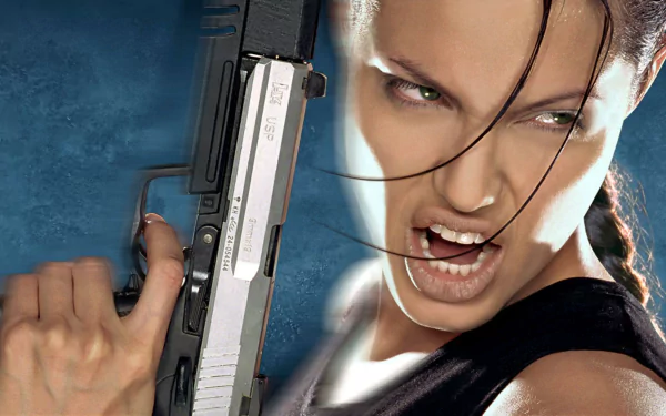 Angelina Jolie as Lara Croft in Tomb Raider, holding a gun with an intense expression, featured in an HD PC desktop wallpaper and background.
