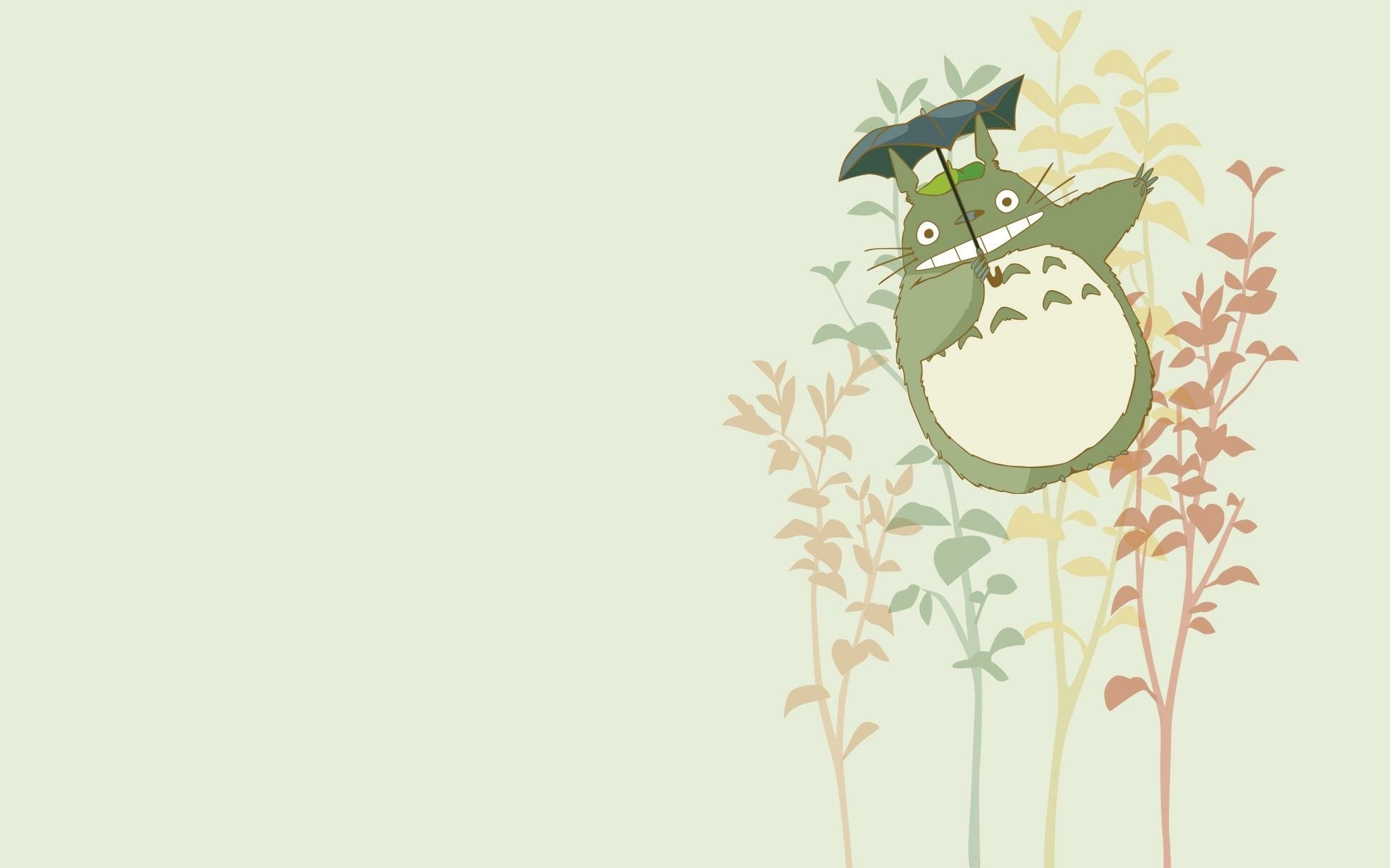 HD desktop wallpaper featuring Totoro from My Neighbor Totoro peeking through gentle flora on a soft green background.