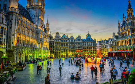 Square in Brussels, Belgium at dusk showcasing historic architecture and vibrant city life, captured in high-definition for a stunning PC desktop wallpaper background.