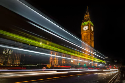 A vibrant time-lapse image of Big Ben in London, illuminated at night, showcasing the iconic tower surrounded by dynamic light trails from passing vehicles. 4K Ultra HD wallpaper.