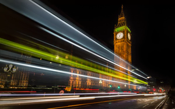 A vibrant time-lapse image of Big Ben in London, illuminated at night, showcasing the iconic tower surrounded by dynamic light trails from passing vehicles. 4K Ultra HD wallpaper.