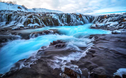 Bruarfoss Waterfall, Iceland — icy winter river and frozen cascades with vivid turquoise water, presented as a 2K Quad HD PC desktop wallpaper/background.