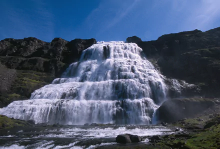 Dynjandi waterfall in Iceland cascading in layered tiers beneath a blue sky — vivid nature scene, HD PC desktop wallpaper and background.