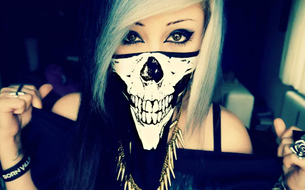 HD desktop wallpaper featuring a young individual with emo style, wearing a skull-patterned face mask, dark eye makeup, and light-colored hair with dark roots. The ambiance is dark.