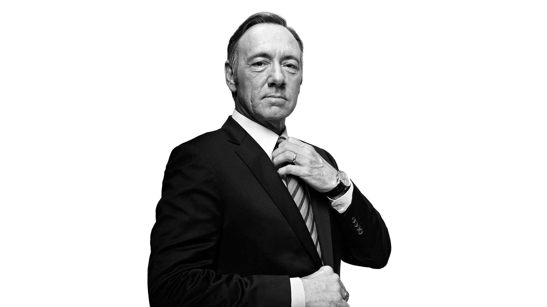 HD PC desktop wallpaper: black-and-white portrait of a stern, suited politician from the TV show House of Cards adjusting his tie against a white background.