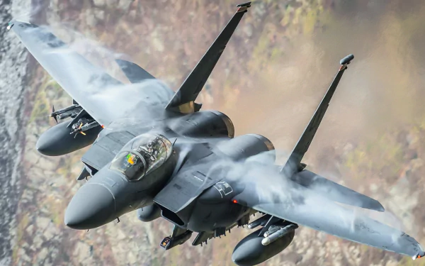 A McDonnell Douglas F-15 Eagle soaring through the sky, depicted in a striking HD desktop wallpaper, showcasing military power and precision in flight.