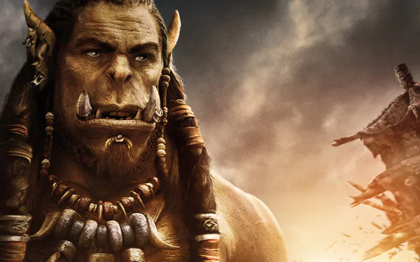 HD PC desktop wallpaper featuring a close-up of an orc character from the Warcraft movie against a stormy sky background.