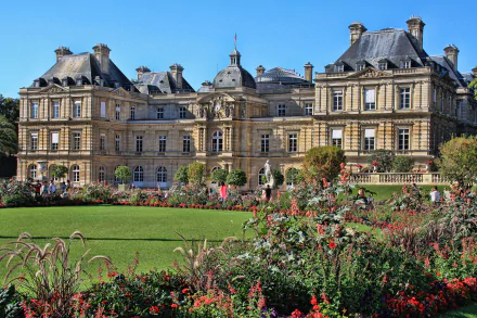 Luxembourg Palace in Paris, France, showcased behind a vibrant garden in this 4K Ultra HD desktop wallpaper and background.