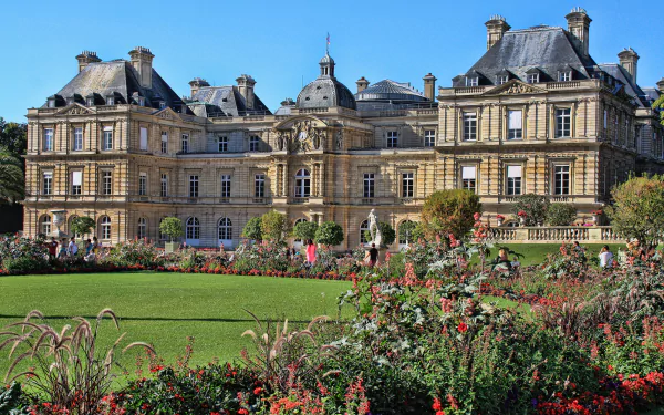 Luxembourg Palace in Paris, France, showcased behind a vibrant garden in this 4K Ultra HD desktop wallpaper and background.
