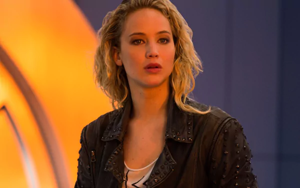 A high-definition image of Jennifer Lawrence as Raven Darkhölme, also known as Mystique from X-Men: Apocalypse, featuring a dramatic expression in a stylized background.