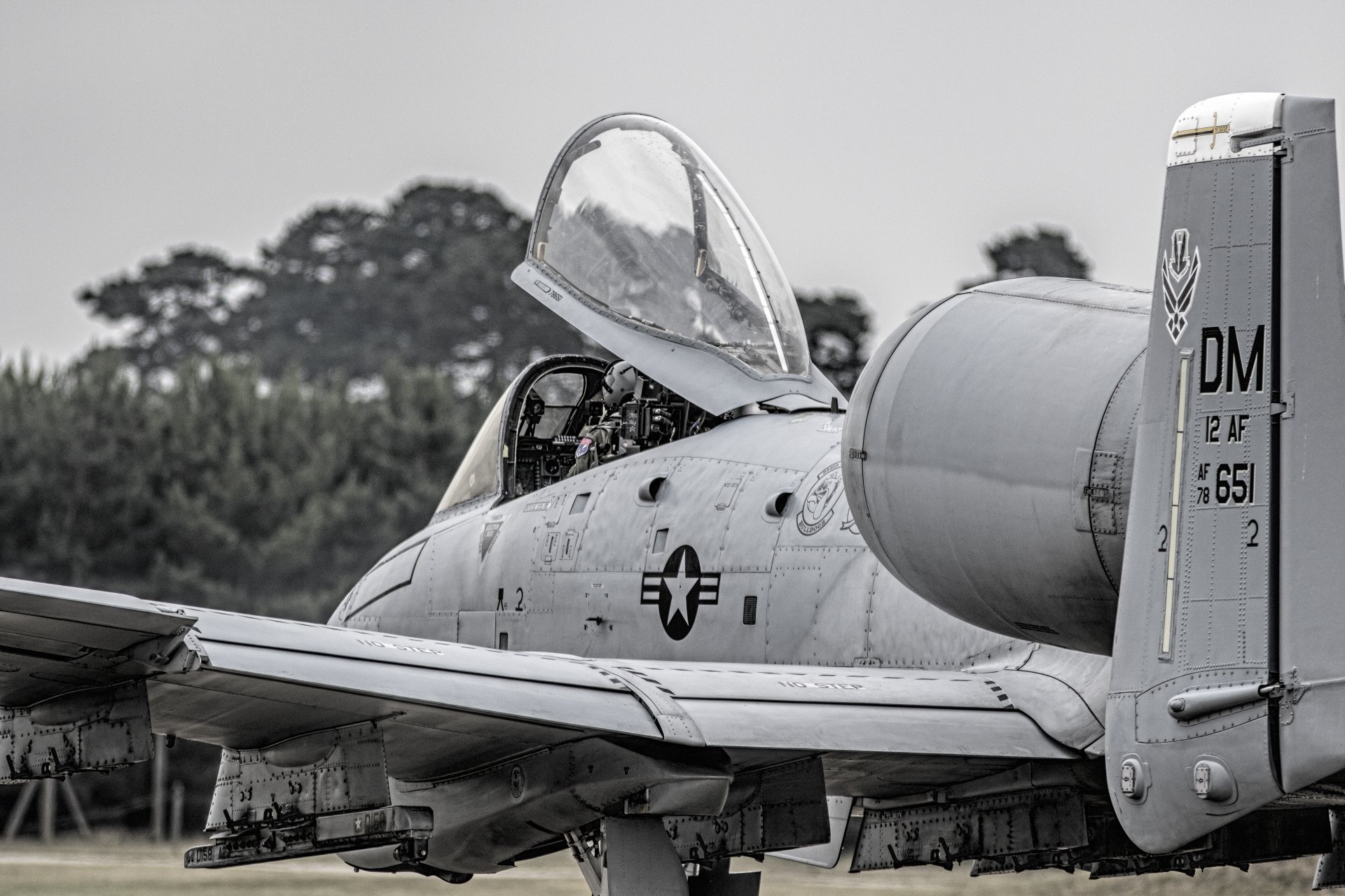Close-up of a Fairchild Republic A-10 Thunderbolt II jet fighter on the ground, showcasing its cockpit and military markings in 4K Ultra HD detail.