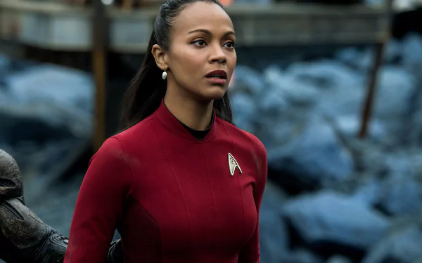 HD desktop wallpaper featuring Zoe Saldana as Uhura from the movie Star Trek Beyond, set against a rugged outdoor background.