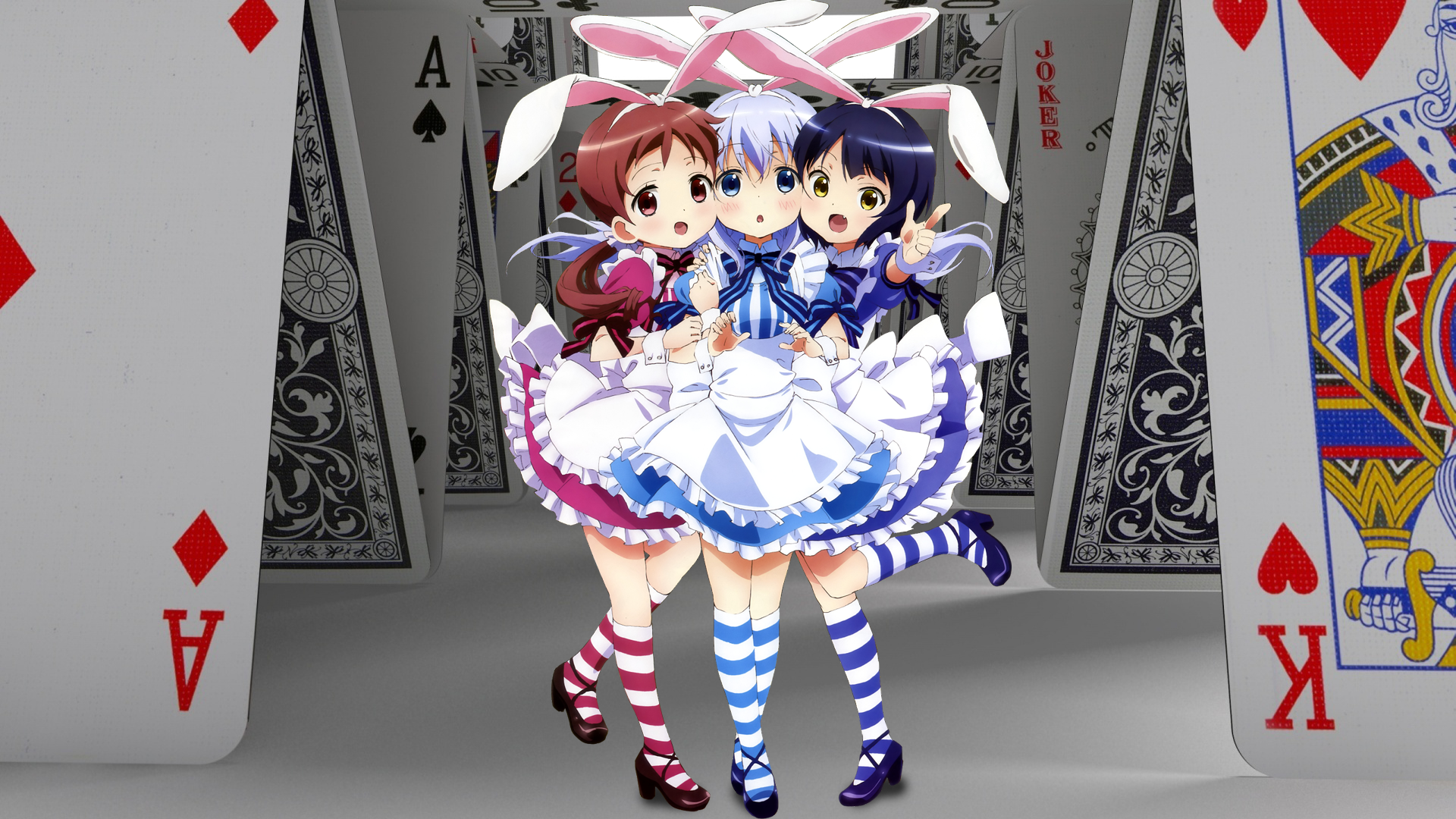 Colorful HD wallpaper featuring anime characters Megumi Natsu, Chino Kafū, and Maya Jouga from Is the Order a Rabbit, set against a backdrop of playing cards.