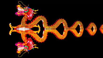 A vibrant Chinese New Year dragon illuminated at night, its bright lights perfectly reflected on the surface below, captured in stunning 4K Ultra HD resolution.