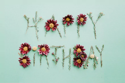 A minimalist HD desktop background featuring the words Happy Birthday creatively arranged with flowers and greenery, set against a soothing mint green backdrop.