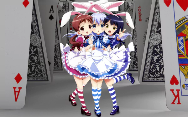 Colorful HD wallpaper featuring anime characters Megumi Natsu, Chino Kafū, and Maya Jouga from Is the Order a Rabbit, set against a backdrop of playing cards.