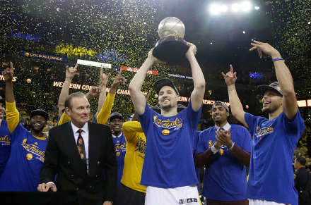 A vibrant HD wallpaper featuring the Golden State Warriors celebrating a championship victory, with players lifting a trophy amidst confetti and cheers.
