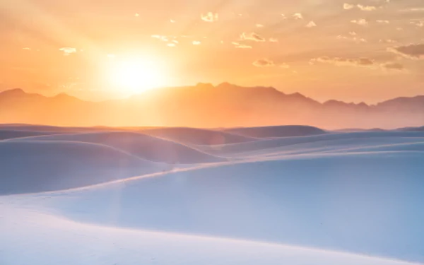 8K Ultra HD PC desktop wallpaper background: golden sunset over Mexico desert dunes with soft light and distant mountains, a tranquil nature scene.